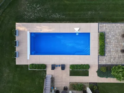 Simple smooth concrete pool patio